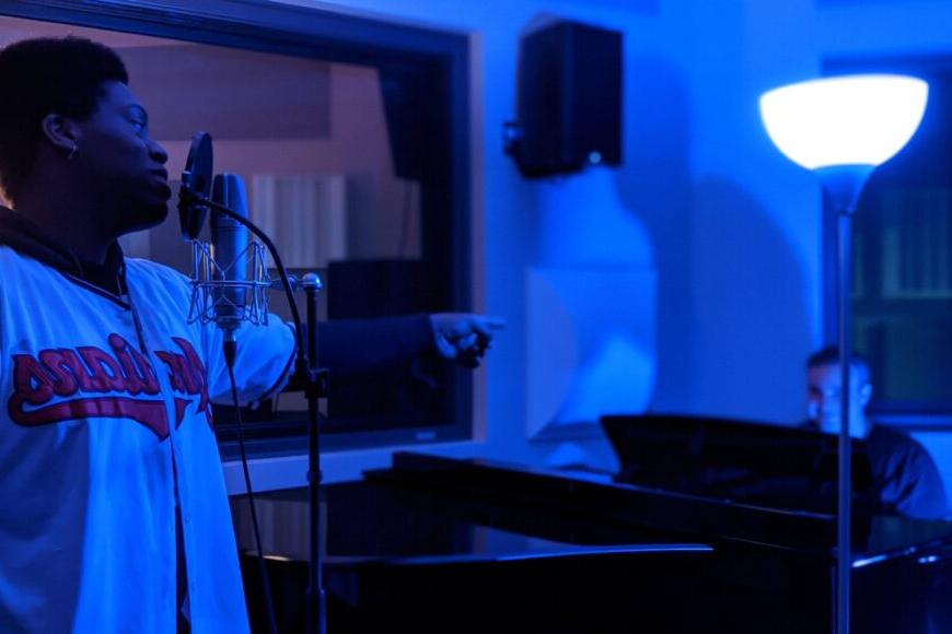 singer in studio with blue light